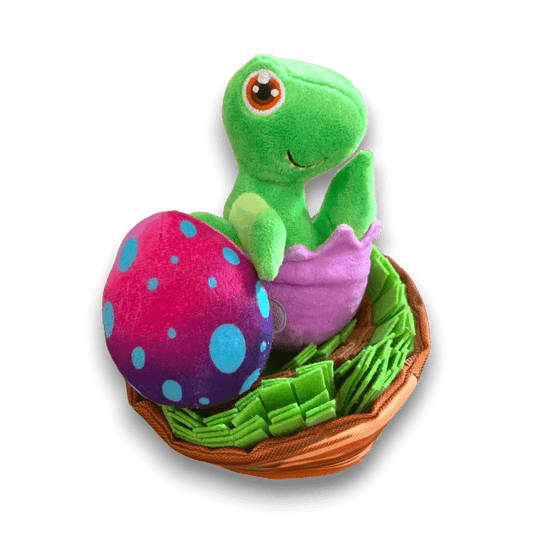 Two part plush dog toy resembling a baby dinosaur coming out of its egg shell and a nest that is made of snuffle material. 