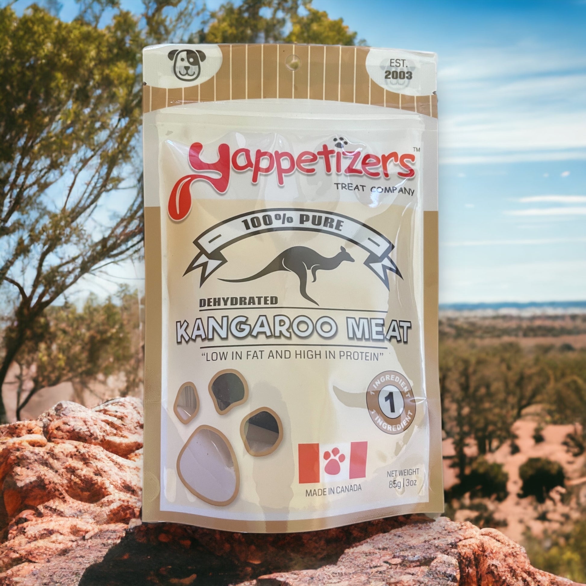 An 85g/3oz bag of natural dehydrated kangaroo made in Canada by Yappetizers. The treat bag is on a rock in the Australian outback.
